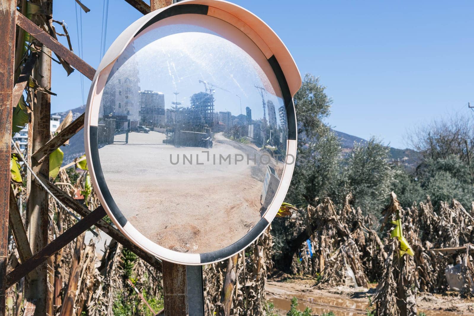 Signs in the form of round convex glass placed on the road, which is dramatically bent so that people can see drivers from the opposite direction. High quality photo