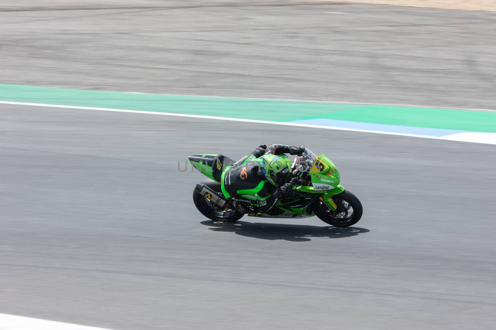 6 may 2023, Estoril, Portugal - MotoGP racing - A person riding a green motorcycle on a race track