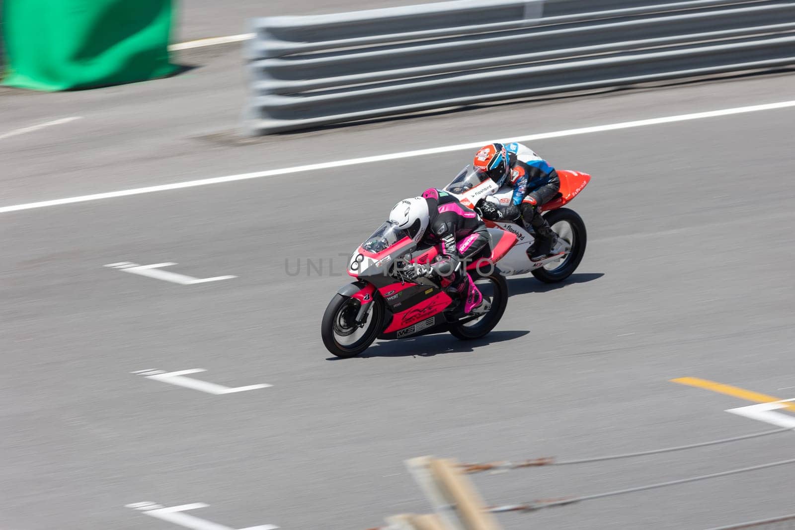 6 may 2023, Estoril, Portugal - MotoGP racing - Two people riding motorcycles on a race track