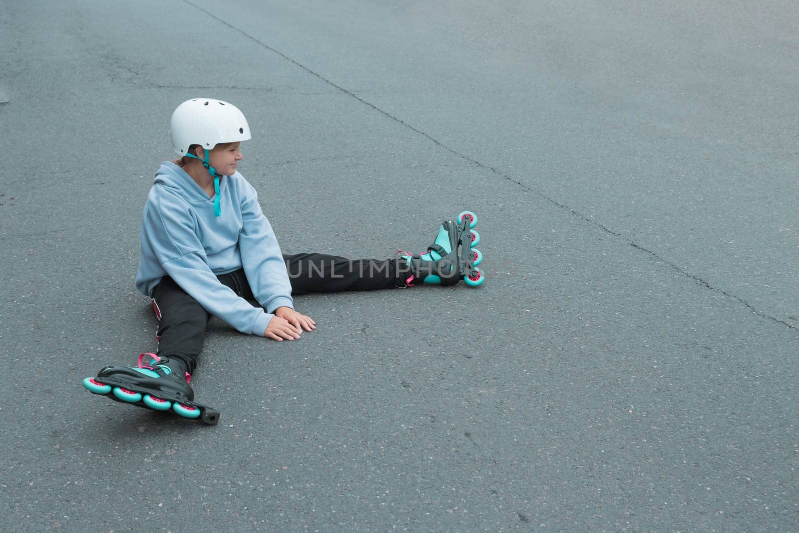 a teenage girl of European appearance in a purple sweater sits in roller by PopOff