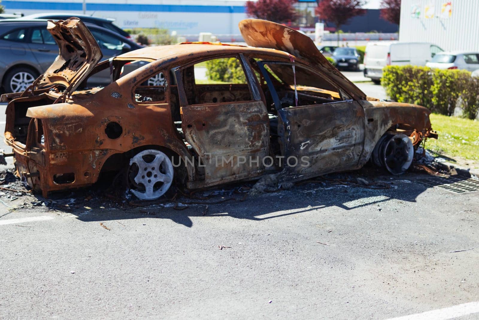 City car burned. Burnt out car with a small flame inside the engine. High quality photo