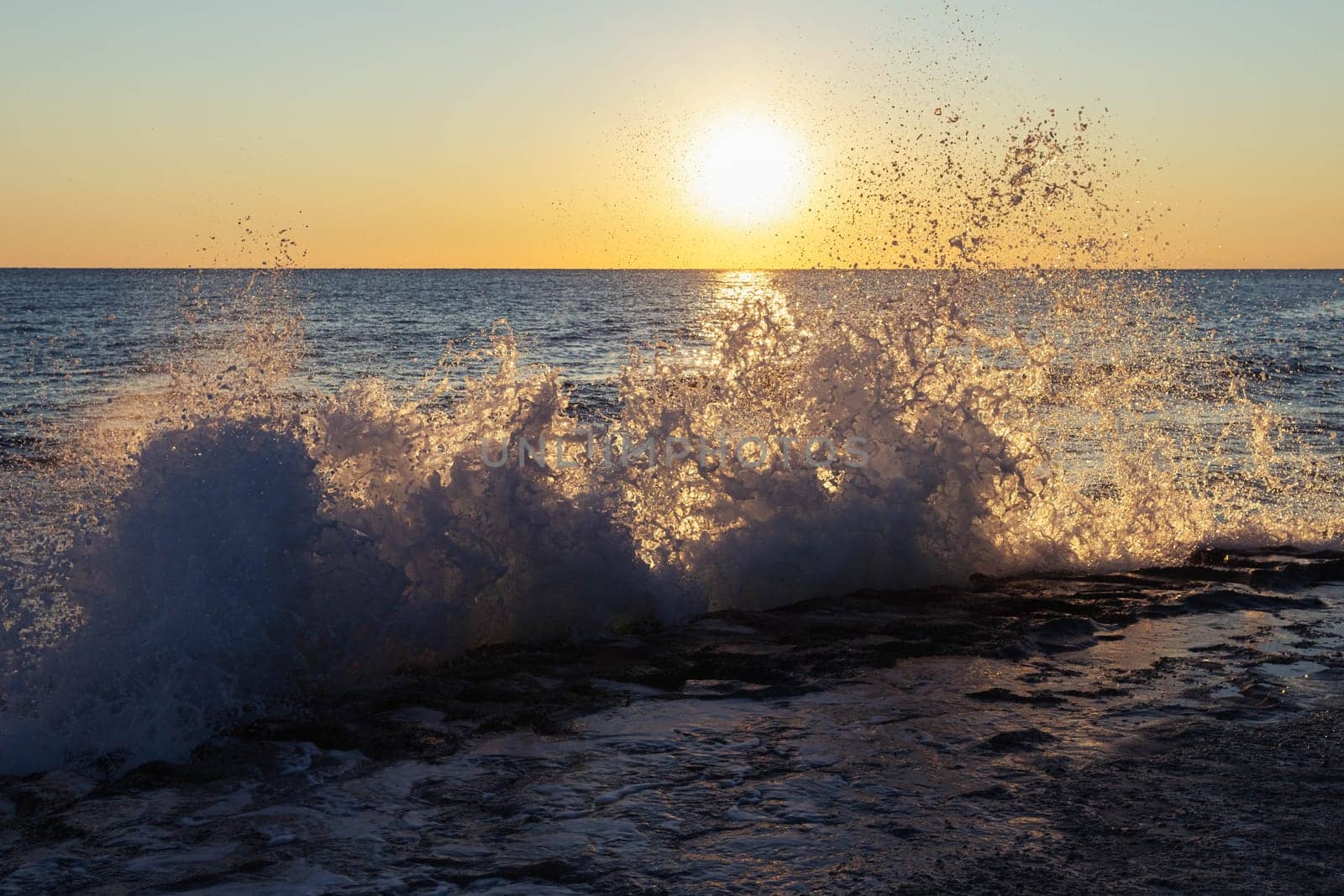 Early morning sunrise on the beach, high tide at dawn. waves beat the sea foam on the sand on the beach. High quality photo
