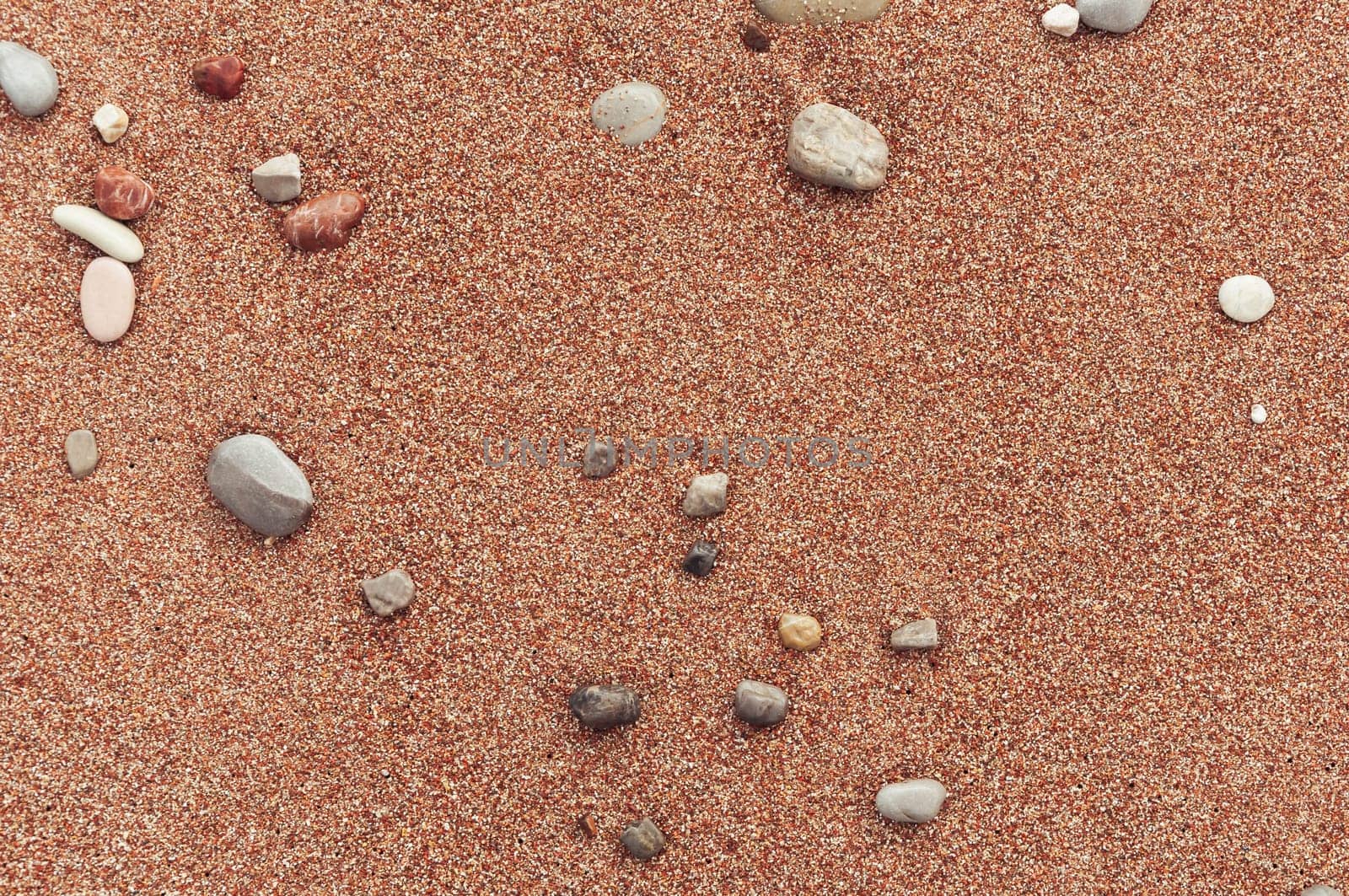 beach with yellow sand close-up, beautiful stones in the frame, background with a place for an inscription. High quality photo