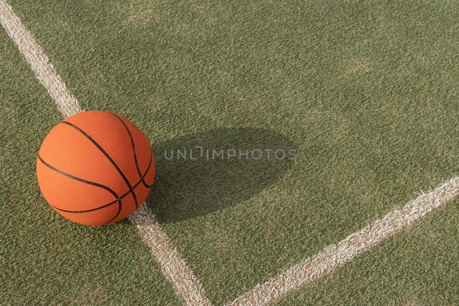 basketball ball isolated on the playing field on the right side there is a place for the inscription by PopOff