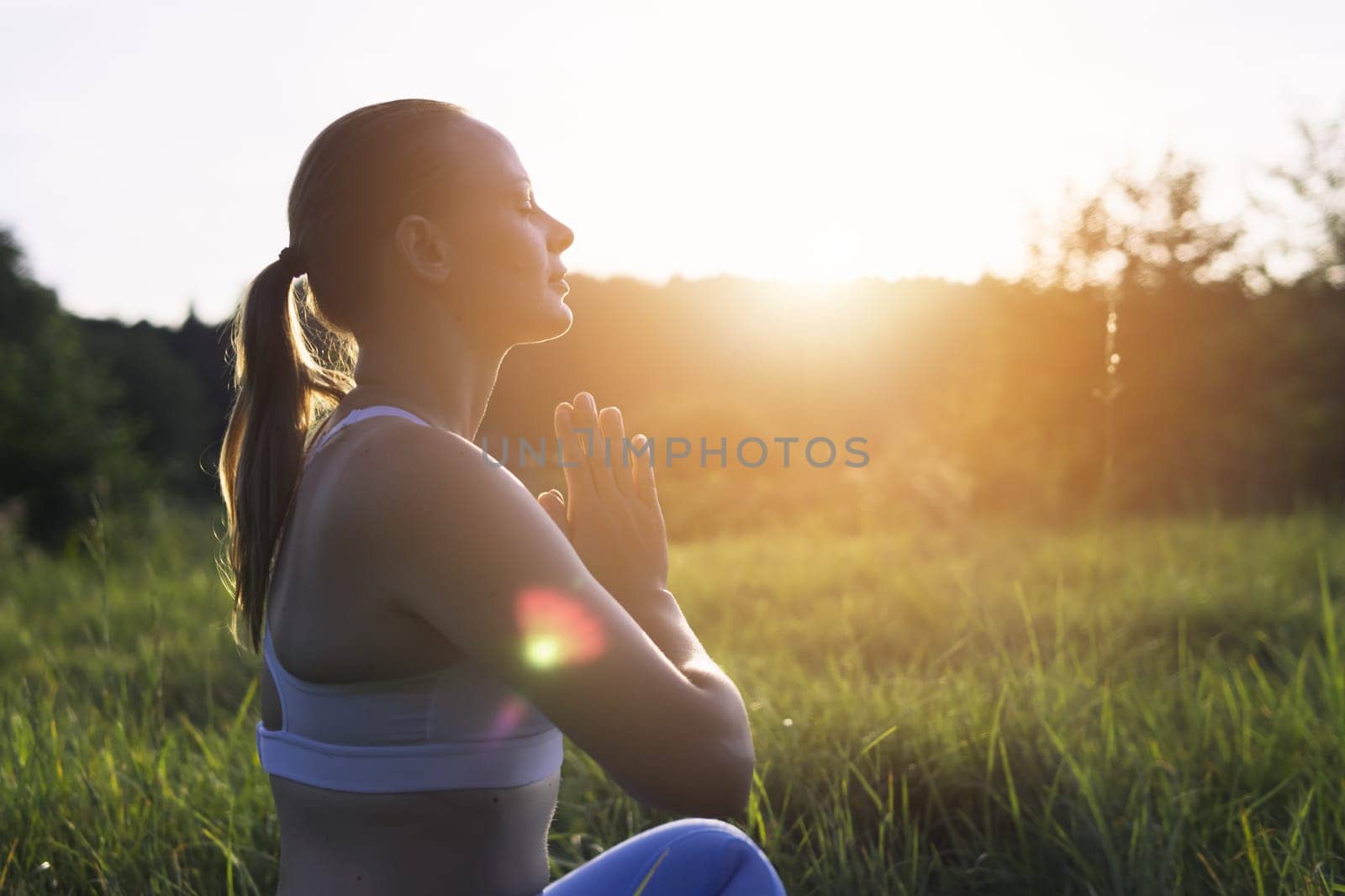 young girl doing yoga outdoors in a suit for fitness. The concept of a healthy lifestyle. there is a place for an inscription. High quality photo