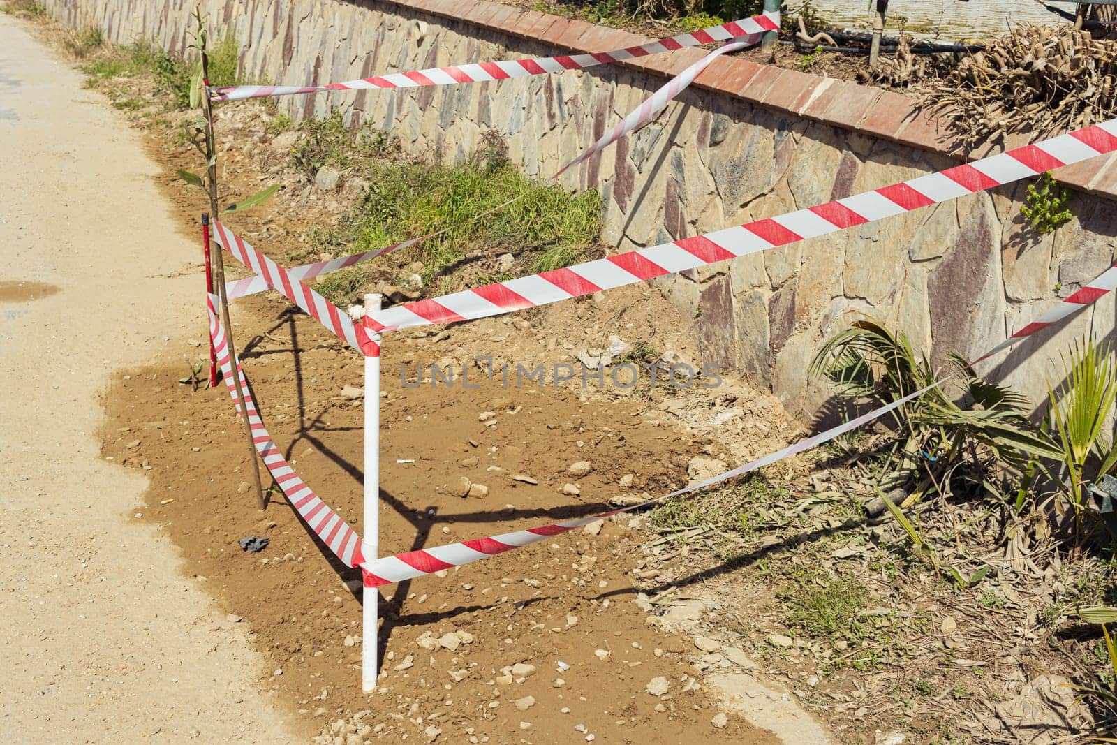 repair of a section of the road, fenced with a red tape so that no one walks. High quality photo