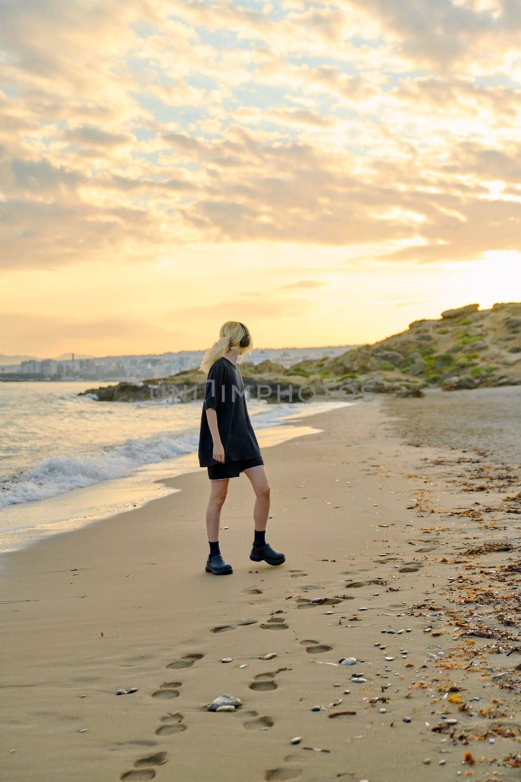 Young teenage female on the beach in the morning by VH-studio