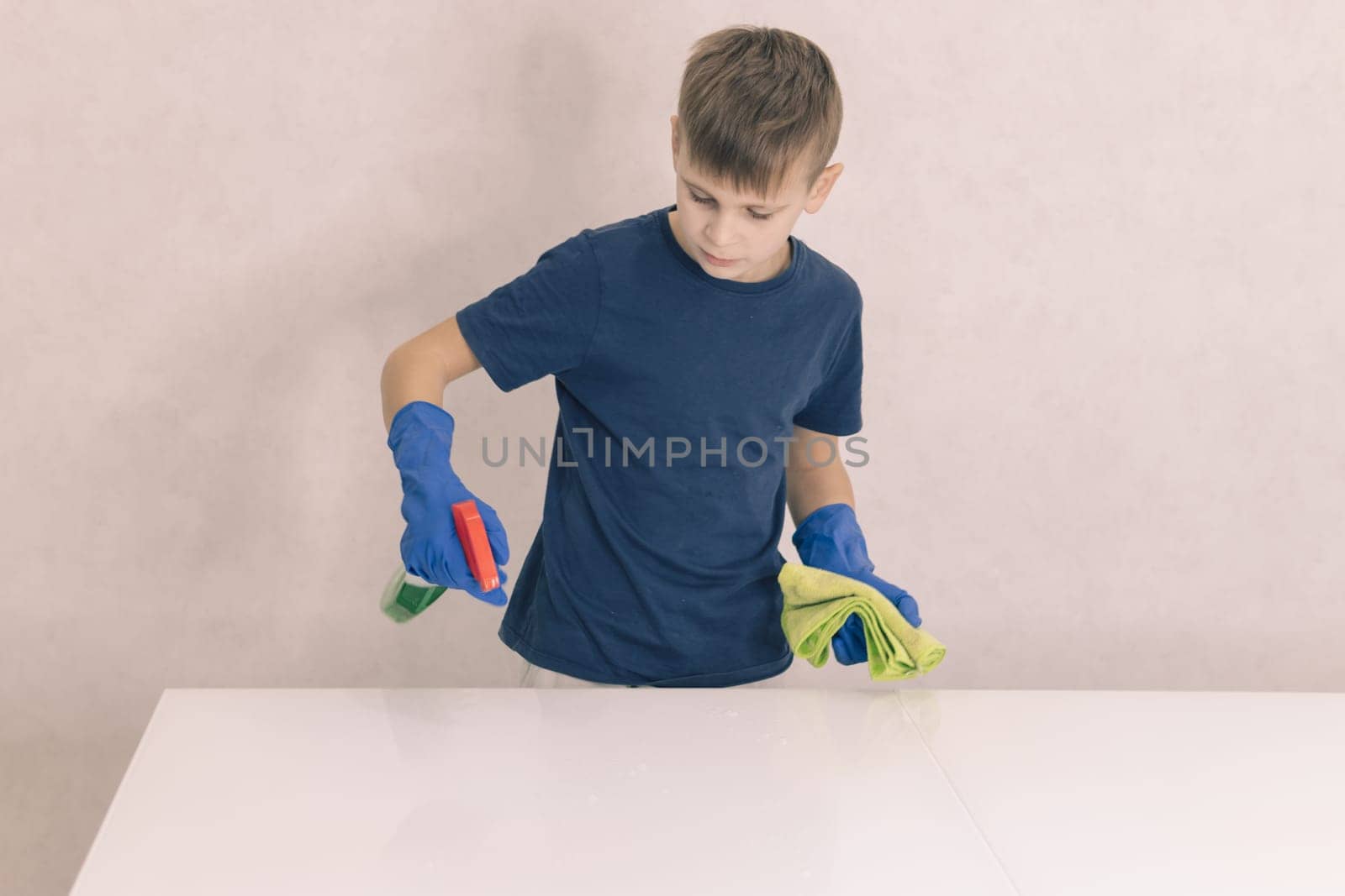 little boy cleans the glass table in the house by PopOff