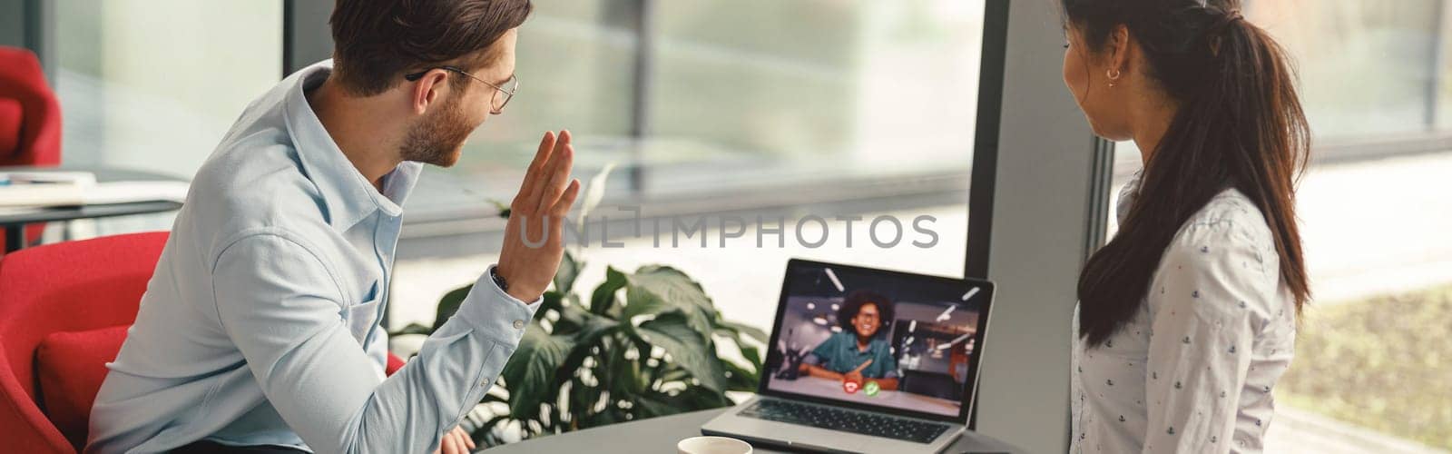 Managers working together on project during online video call meeting in office. High quality photo