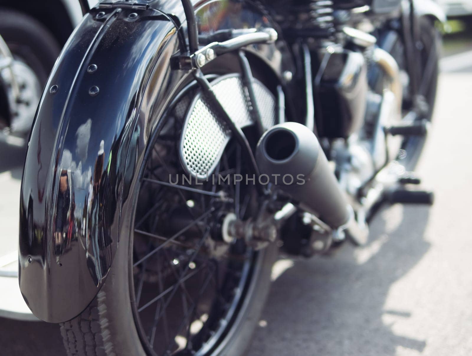 motorcycle rear wheel close-up, isolated motorcycle wheel on the street at the exhibition background blurred. High quality photo