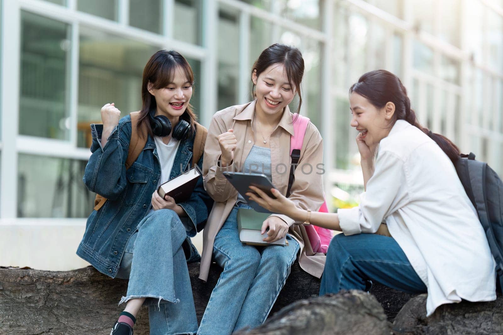 university students using a digital tablet while walking to next class.