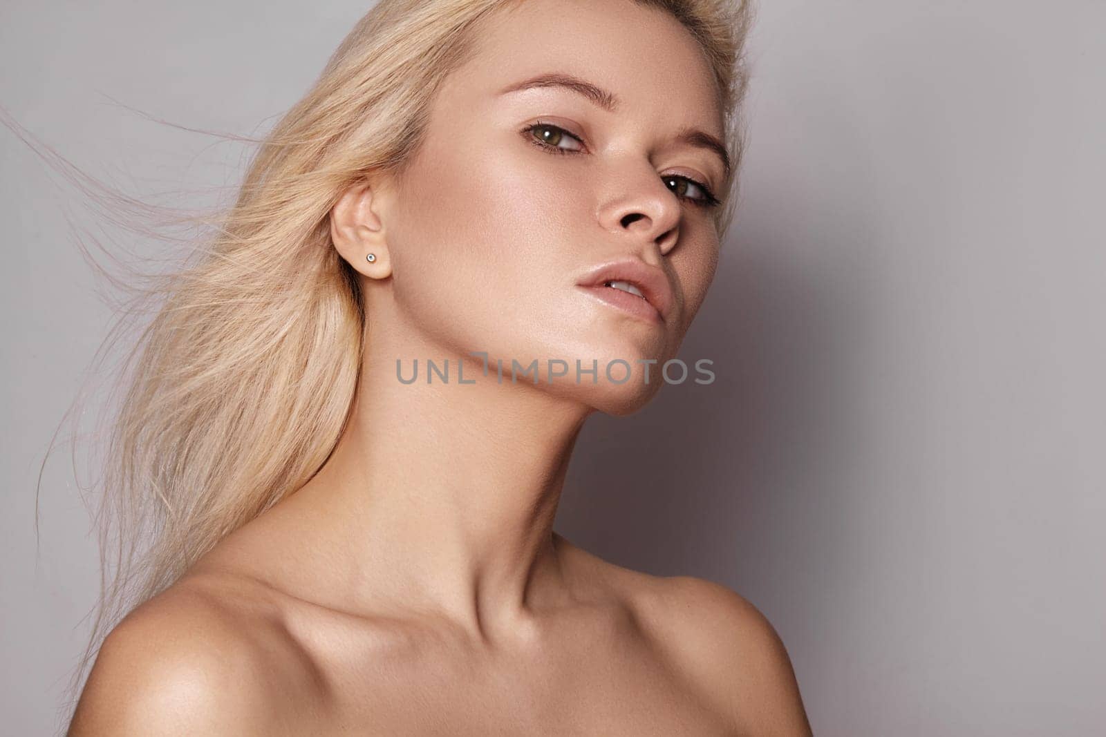 Beautiful woman with magnificent blond hair. Happy model face with windswept flying hair. Shiny long health hairstyle by MarinaFrost