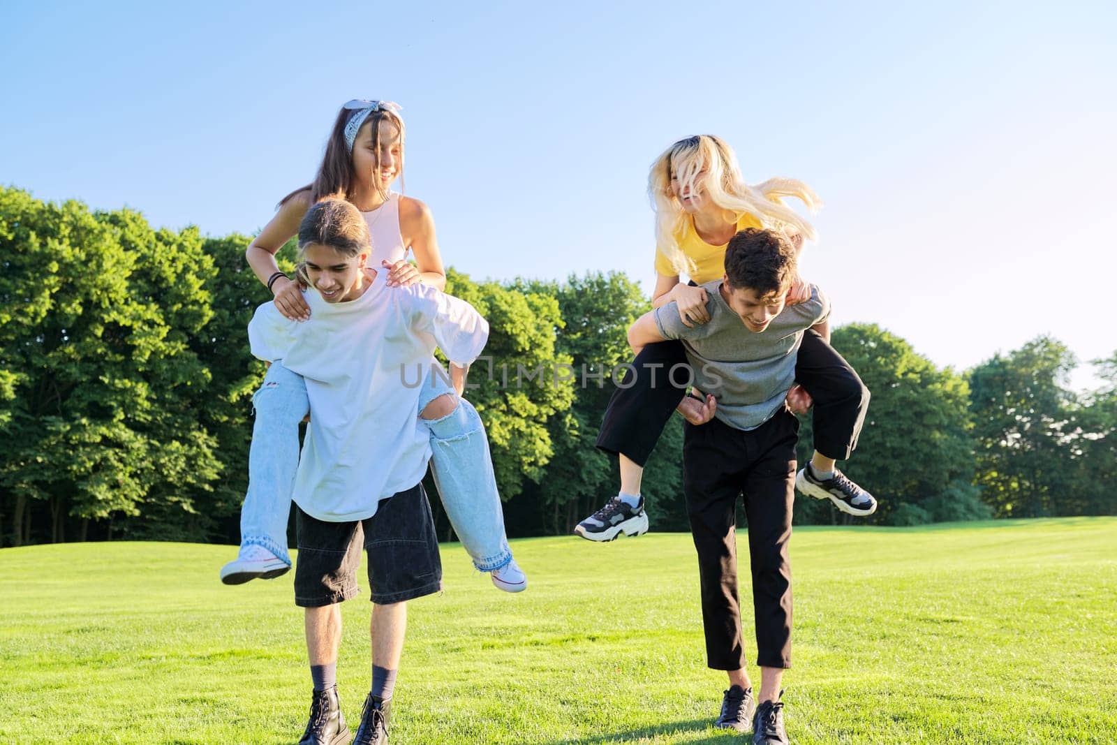 Teenage youth having fun in the park, happy laughing friends. by VH-studio