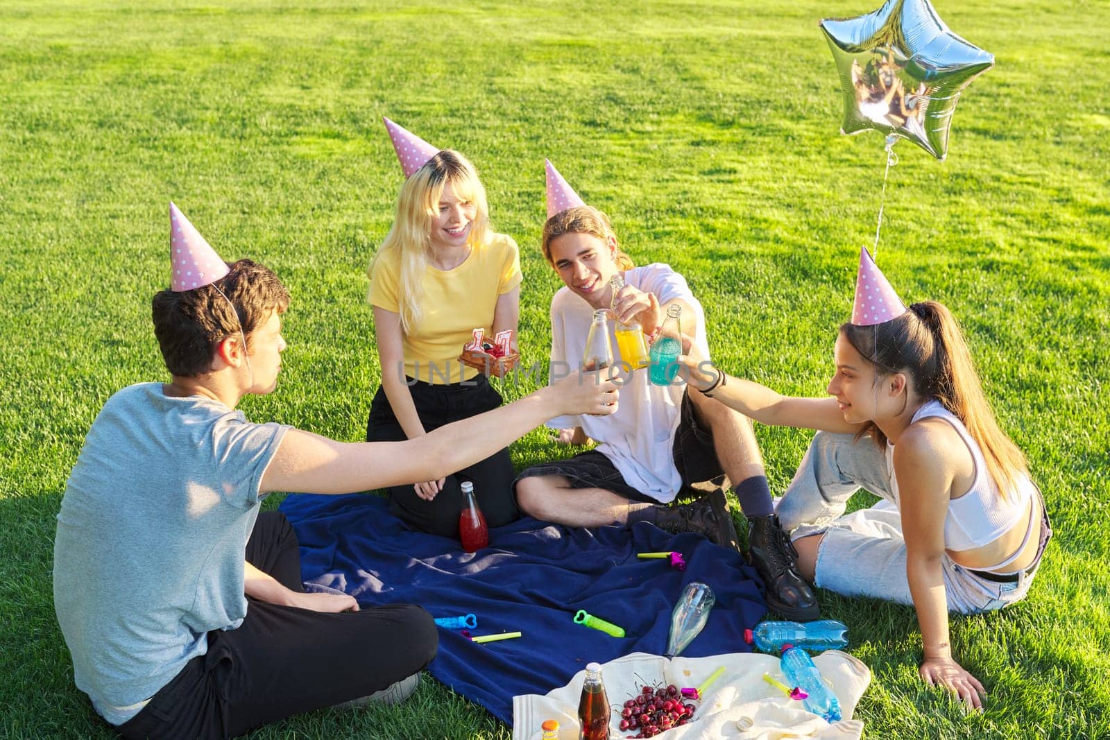 Teenage birthday party picnic on the grass in the park by VH-studio