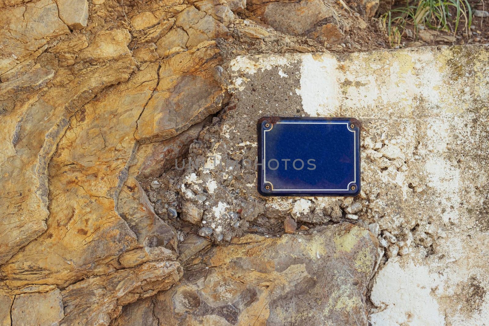 a sign for the inscription on the street on the wall is attached in blue. High quality photo