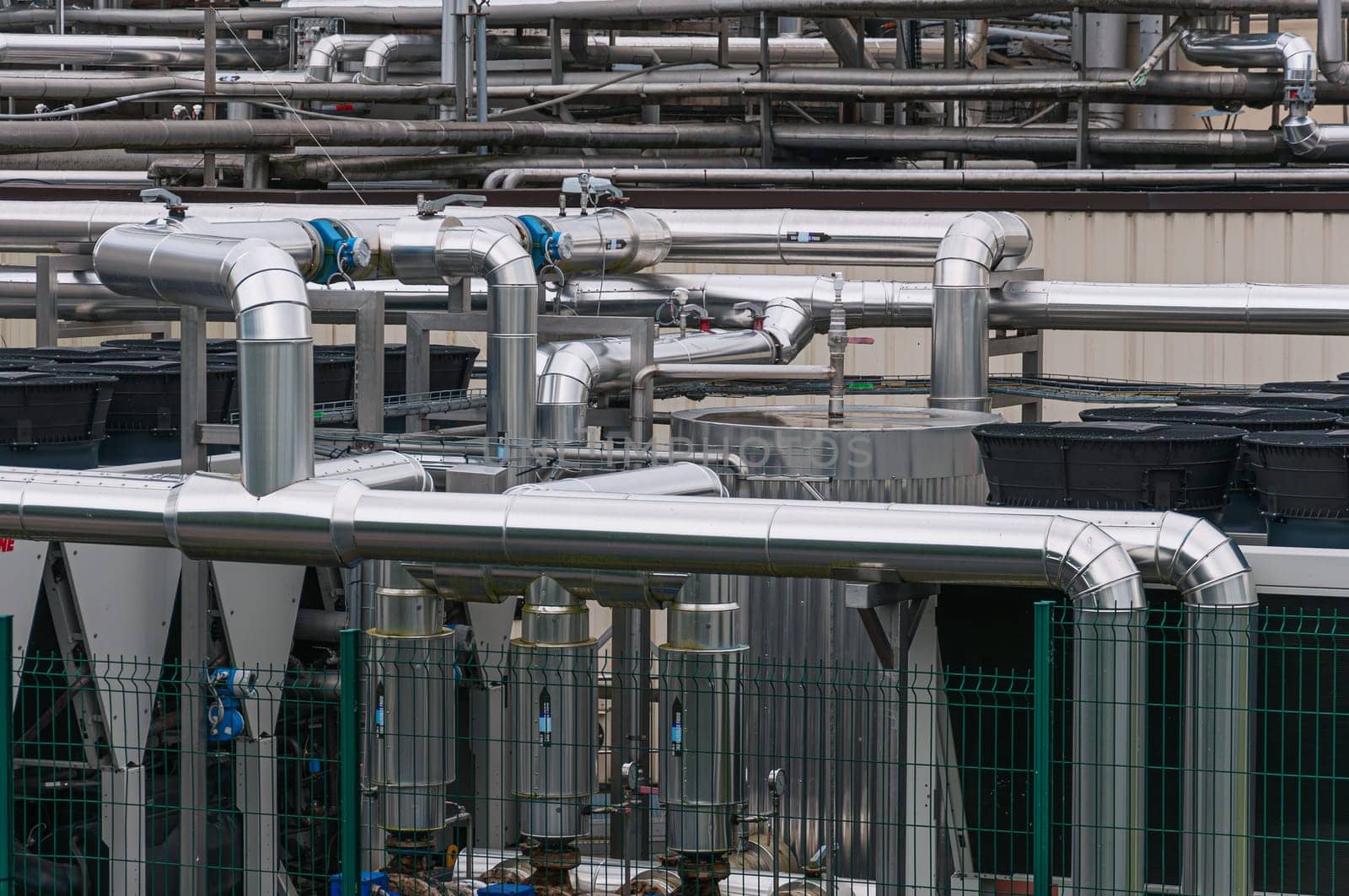 Equipment, cables and pipelines outside a modern cheese factory in France, close-up. High quality photo