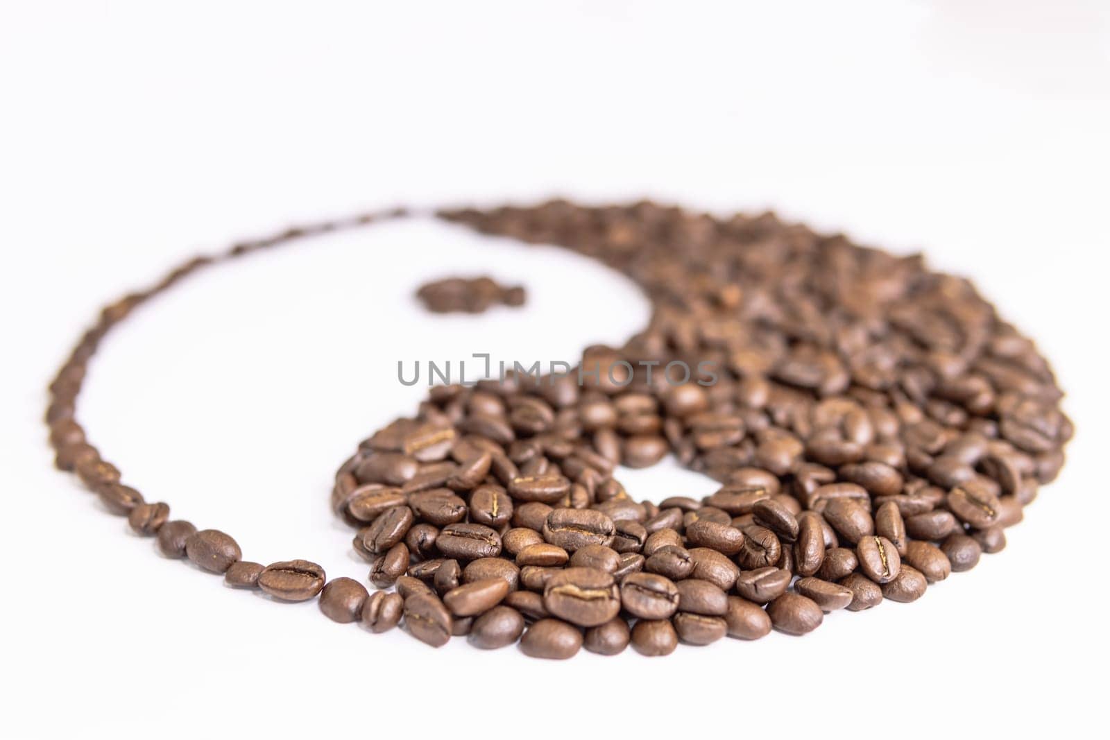 yin yang sign made by coffee beans on white background by PopOff