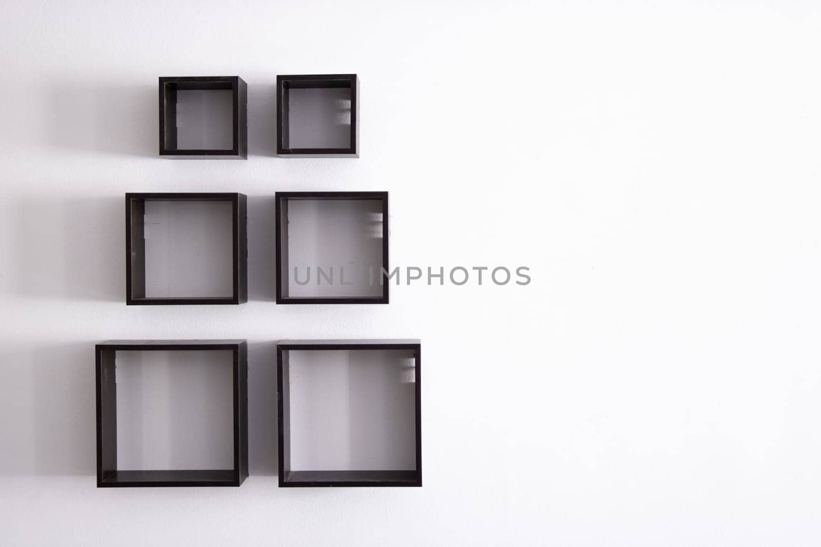 designer shelves on a white wall in an apartment.Design concept by PopOff