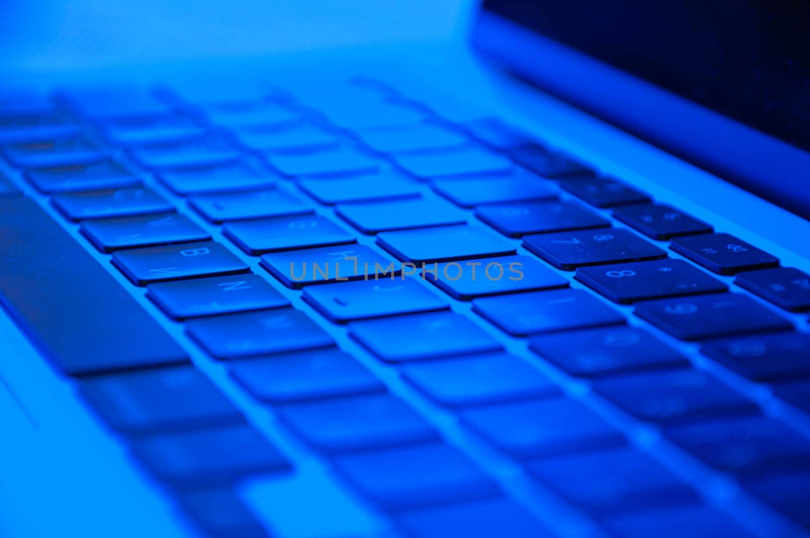 laptop keyboard close up with RGB lighting, side view by PopOff