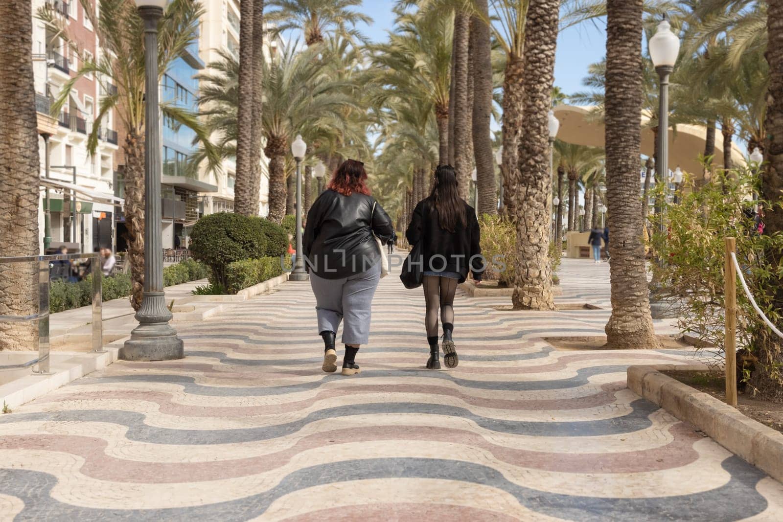 A girl with obesity problems walks with a friend around the city. The girl has problems with being overweight by PopOff