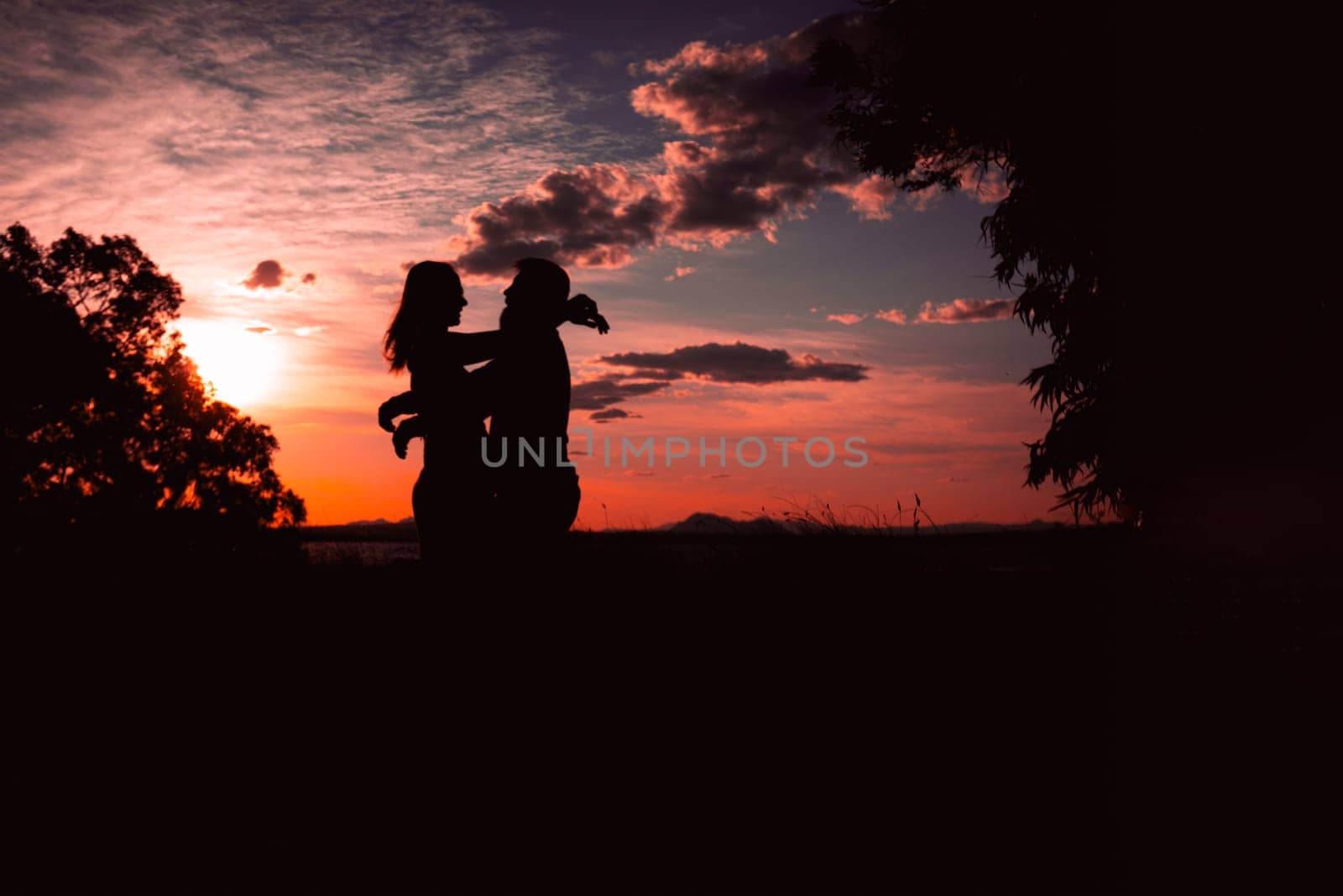 Couple dancing salsa at sunset,silhouette of couple in love at sunset against the backdrop of nature by PopOff