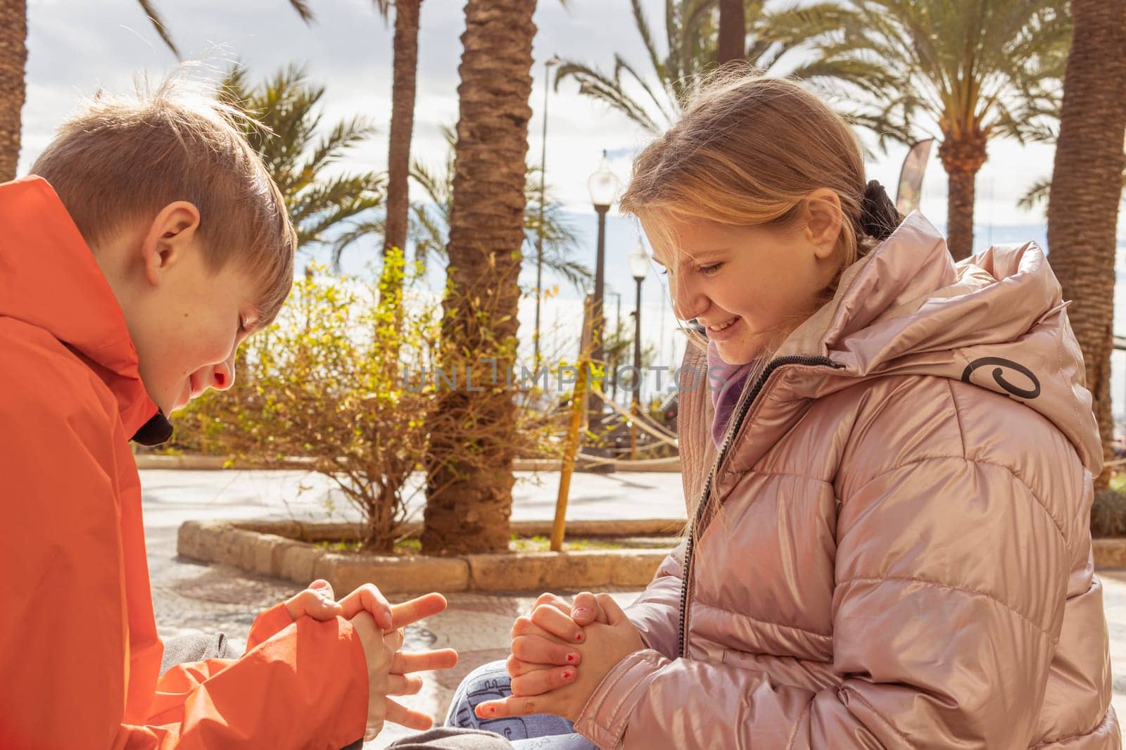 happy children sit on the embankment play while sitting on a bench. High quality photo