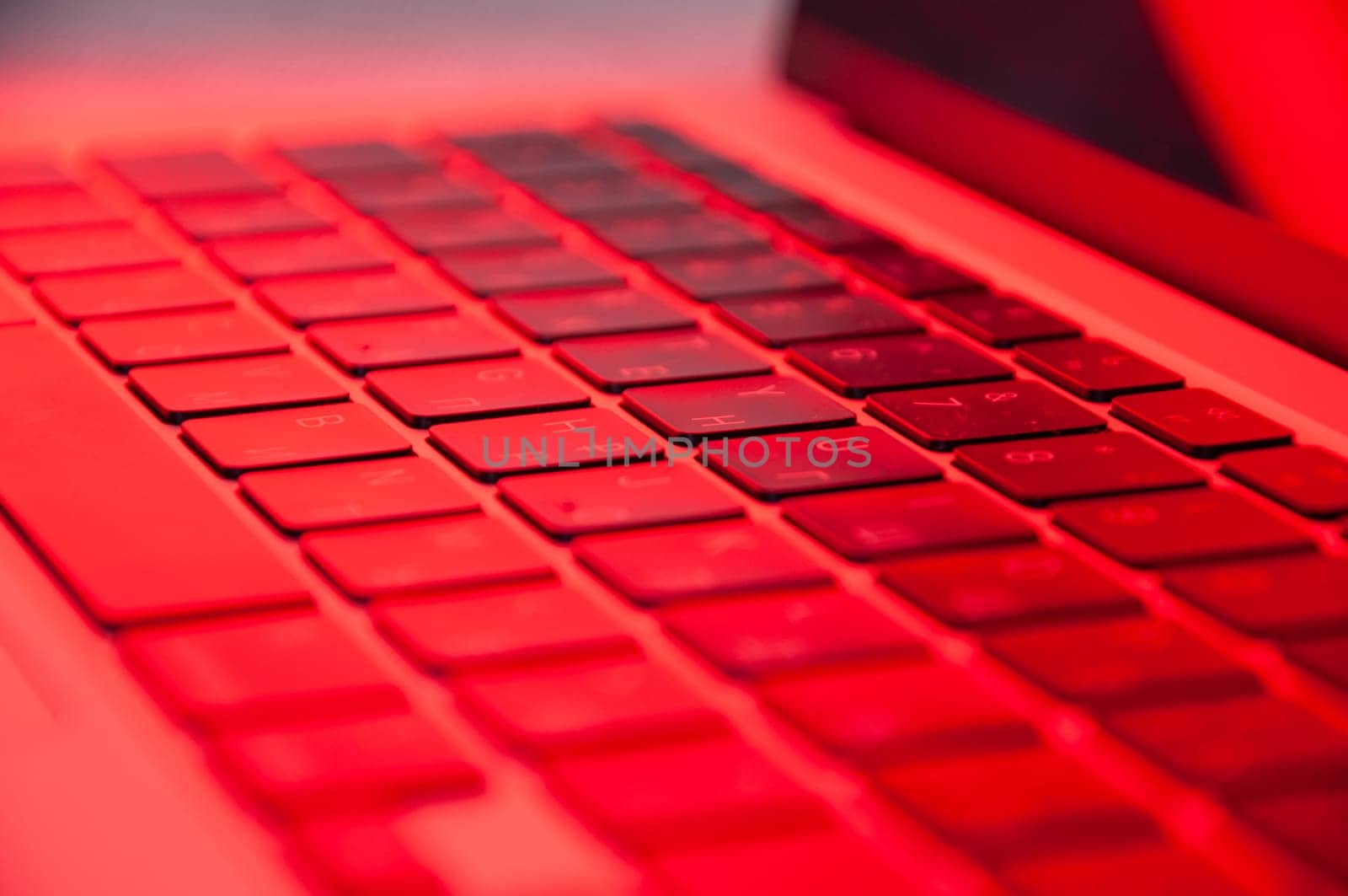 laptop keyboard close up with RGB lighting, side view. High quality photo