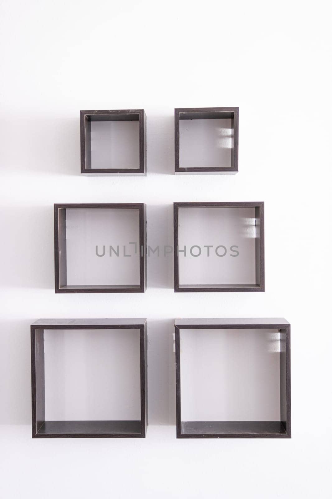 designer shelves on a white wall in an apartment.Design concept by PopOff