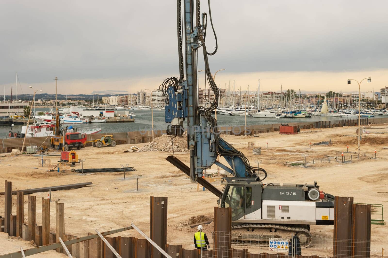 large construction near the pier with yachts there is a place for an inscription, the concept of a large construction site. High quality photo