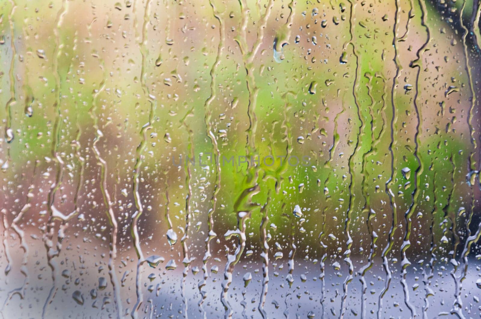 Rain drops on green background. there is a place for an inscription by PopOff