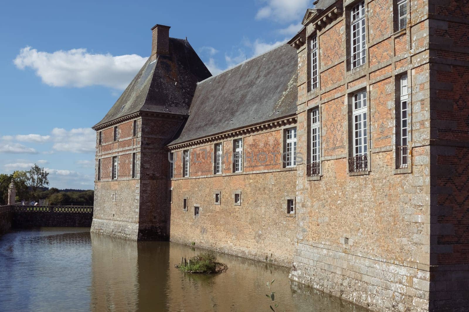 The ancient building of the chateau in France around the lake building, the building close-up has a place for the inscription by PopOff