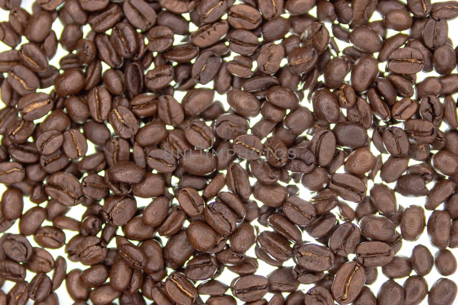 Roasted coffee beans background. coffee beans on a light background by PopOff