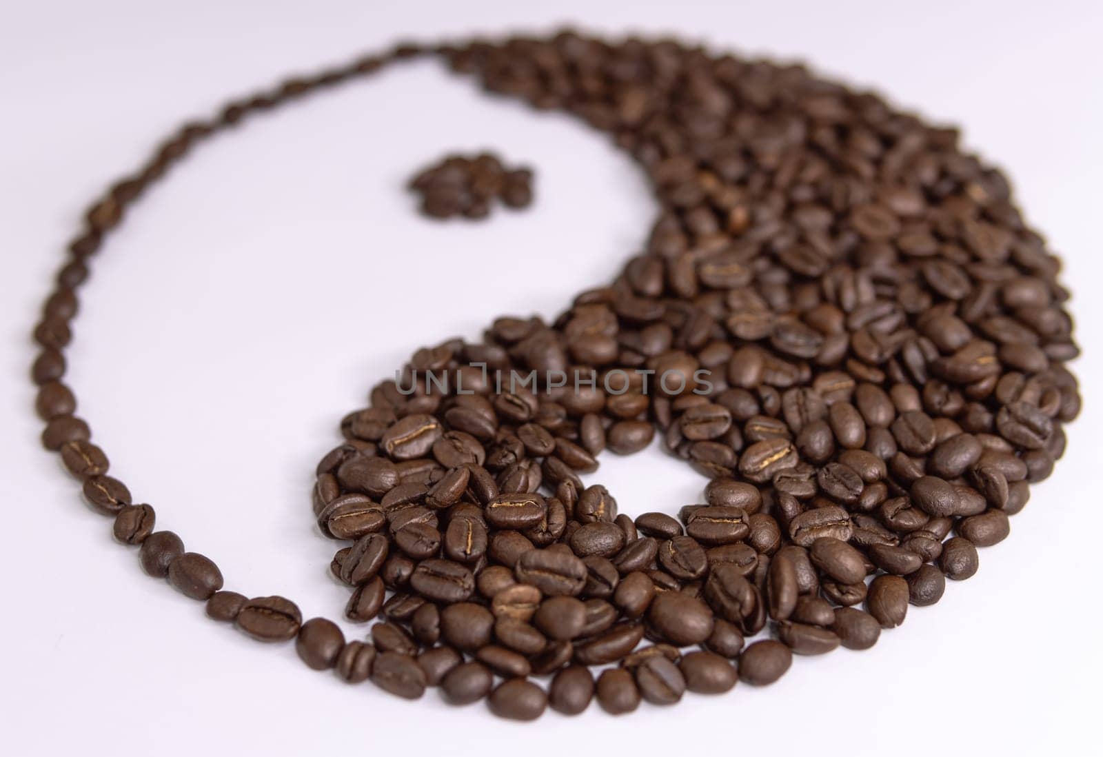 yin yang sign made by coffee beans on white background by PopOff
