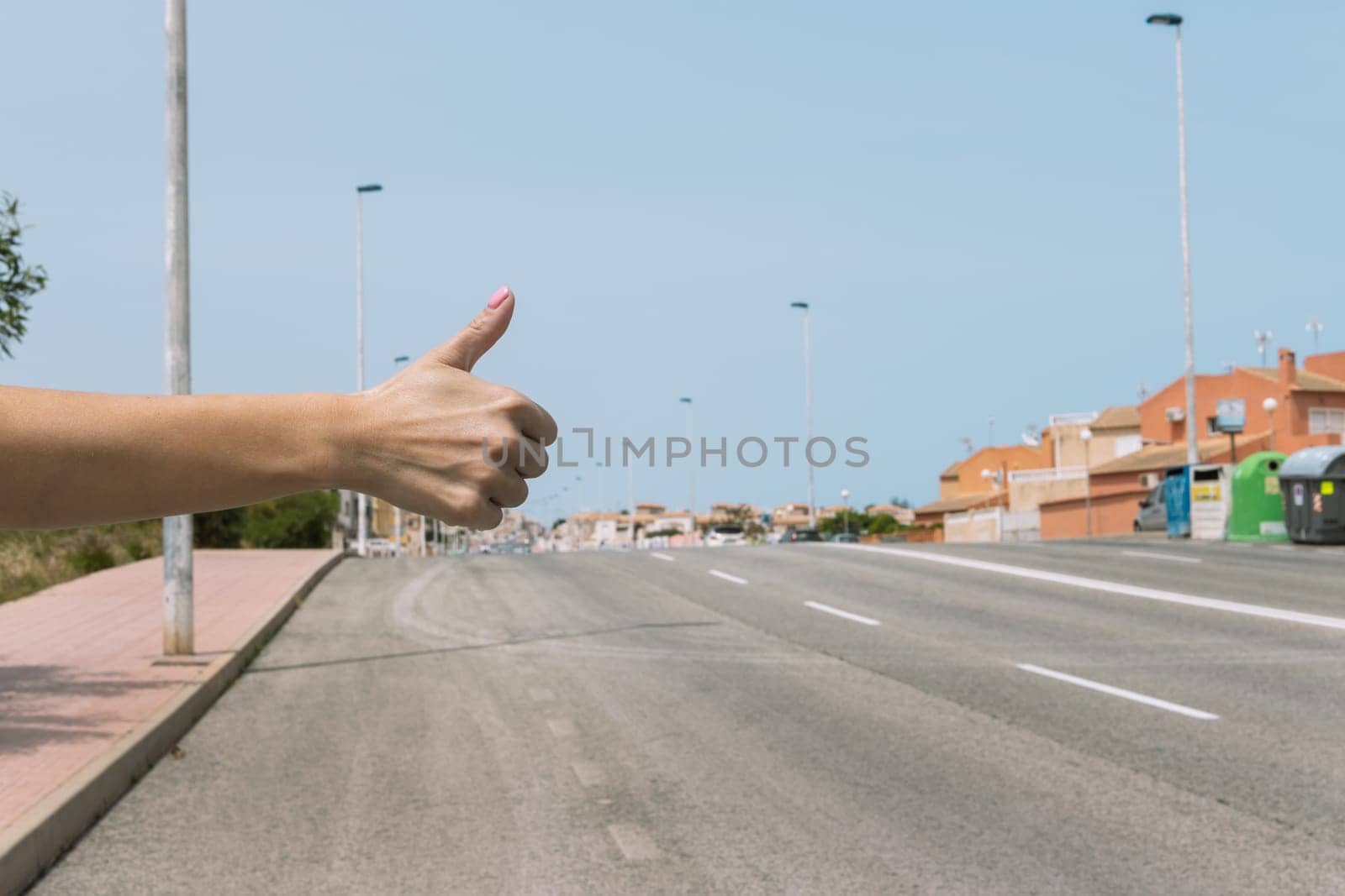 female hand close-up raised finger up, a young girl stops the car,. High quality photo