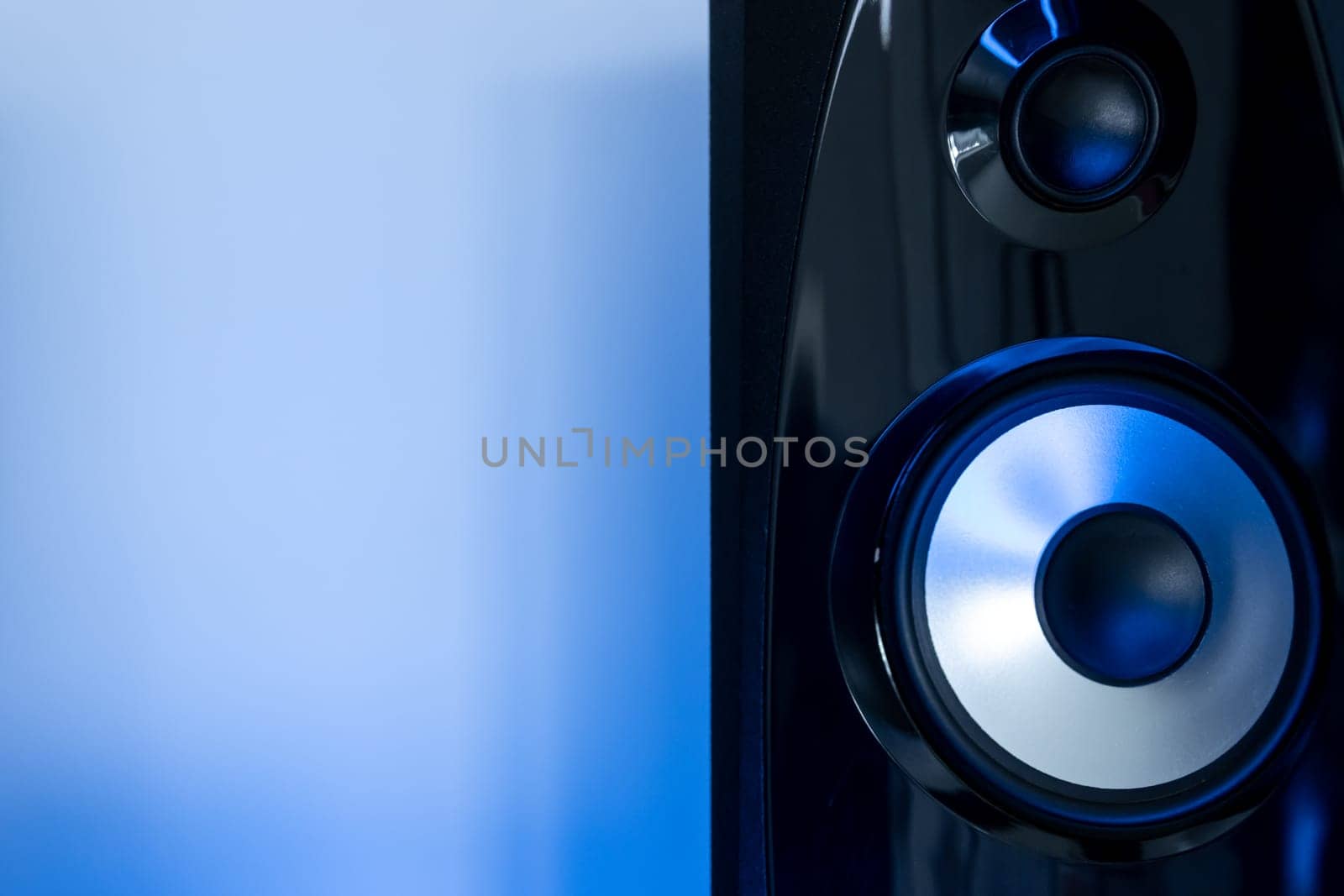 sound speaker with free space on the side on a blue background. High quality photo