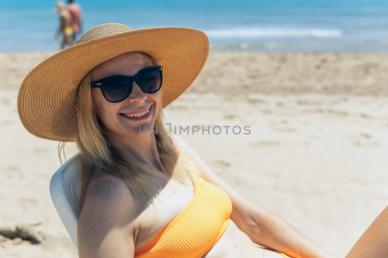 Smiling girl enjoys her vacation by the sea with copy space. The woman relaxes. by PopOff