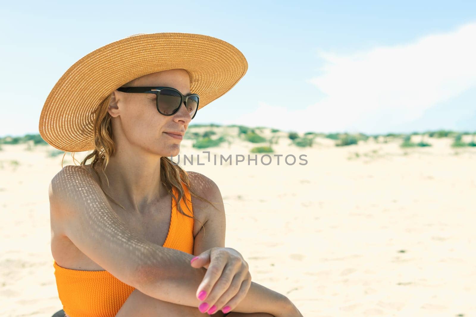 portrait of a girl in a swimsuit, glasses and a hat on the beach, Photo of a seascape with a girl. High quality photo