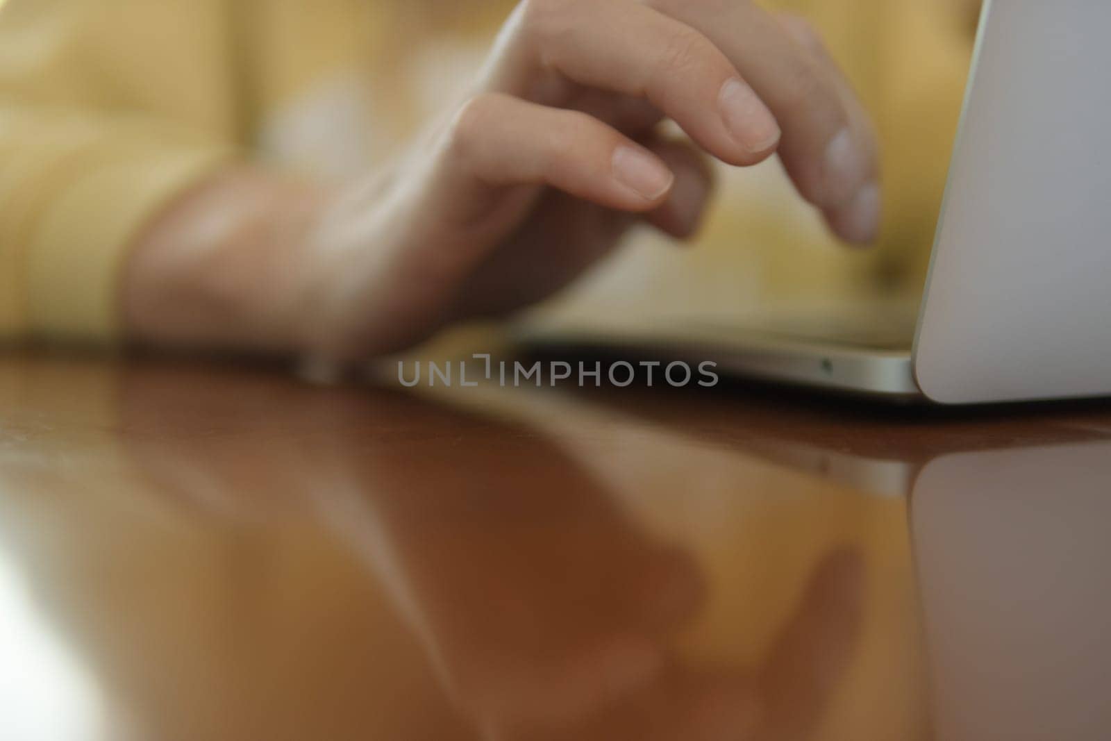 a woman uses a laptop, a close-up on her hands. There is a place for an inscription by PopOff