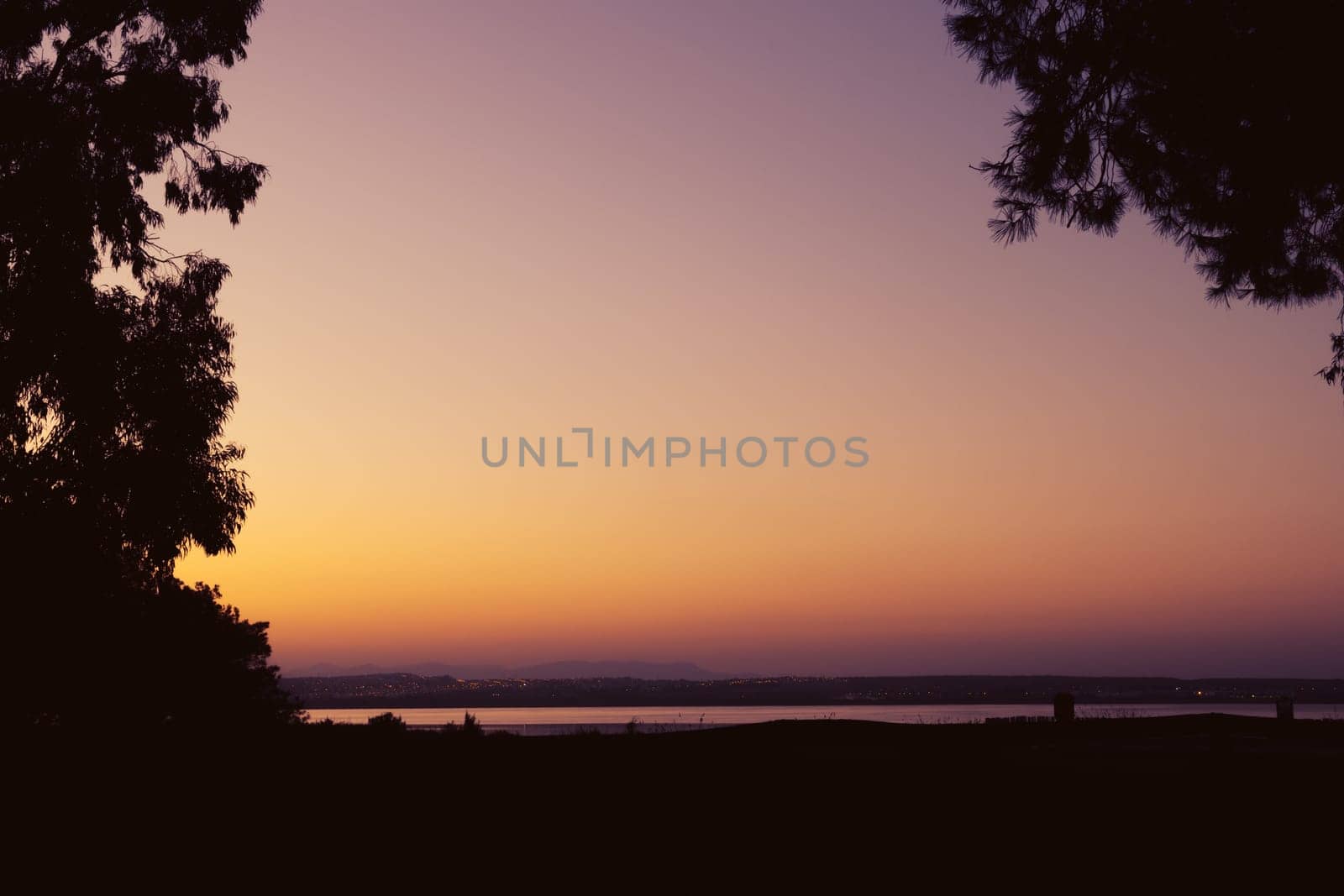 Beautiful photo of nature at sunset. beautiful sunset against the backdrop of trees and a lake. by PopOff