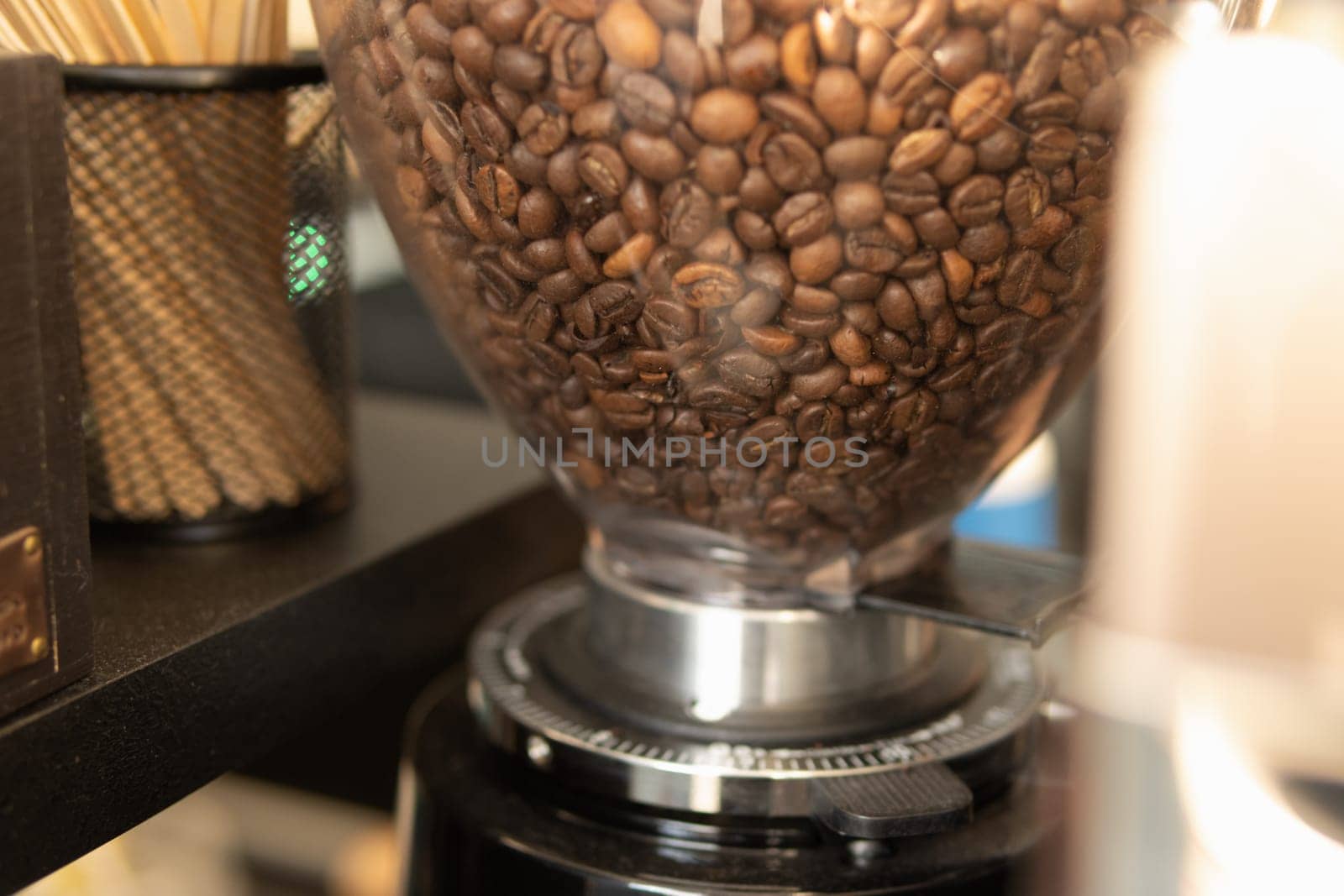 coffee grinder with coffee beans in a coffee shop close-up by PopOff