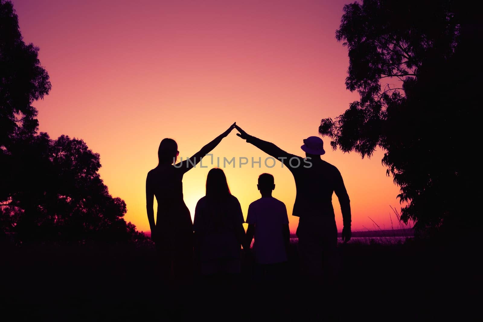 Happy parents making home for kids in beautiful nature,silhouette of the family. concept of family by PopOff