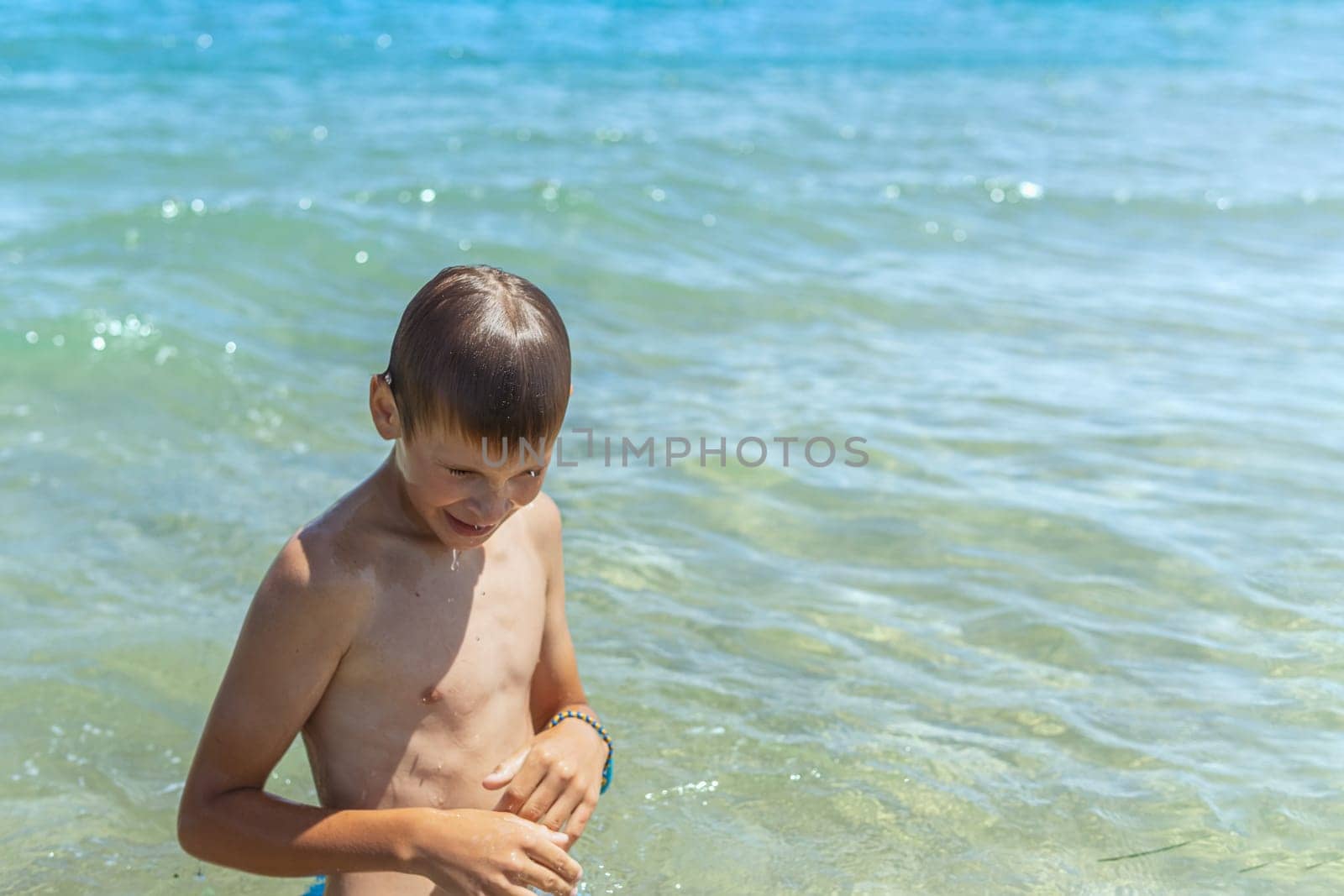 Happy boy swims and dives underwater. Active healthy lifestyle, water sports and activities with parents on summer family vacation with child. High quality photo