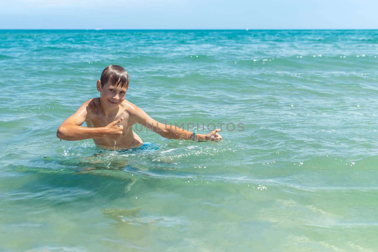 Happy boy swims and dives under water Active healthy lifestyle, water sports, seascape with a child by PopOff