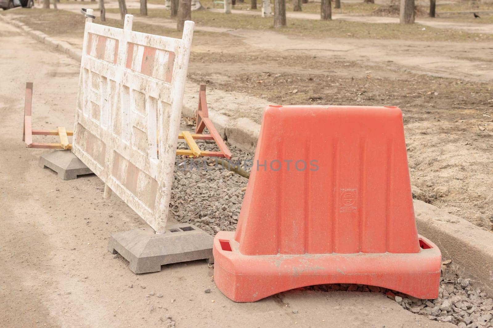 Red plastic road barriers, road fence on a city street. road under construction. High quality photo