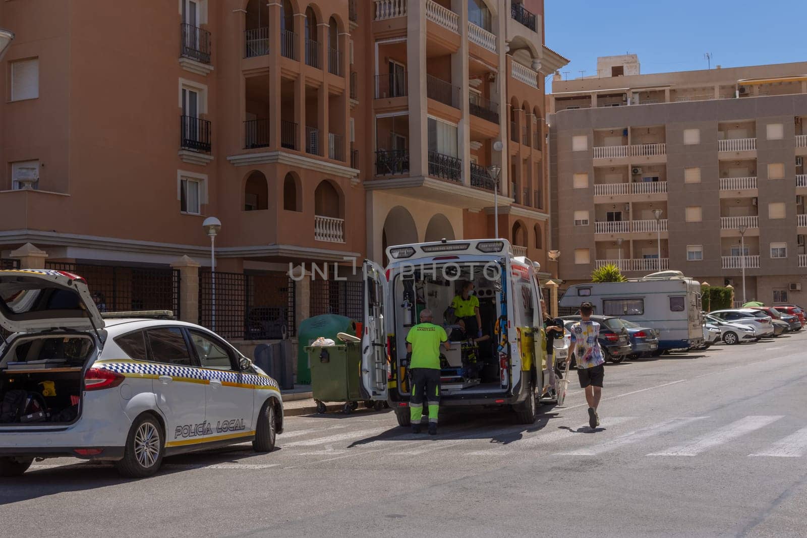 knocked down a man in the city on the road, Spain, Torrevieja on May 28, 2023, an ambulance on the road picks up a person injured. High quality photo