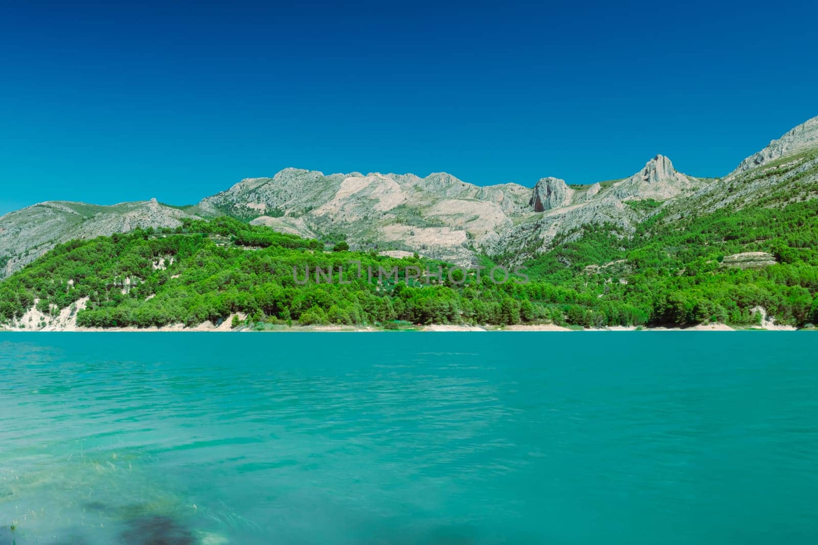 A beautiful mountain landscape, a view of the mountains and a lake with turquoise water by PopOff