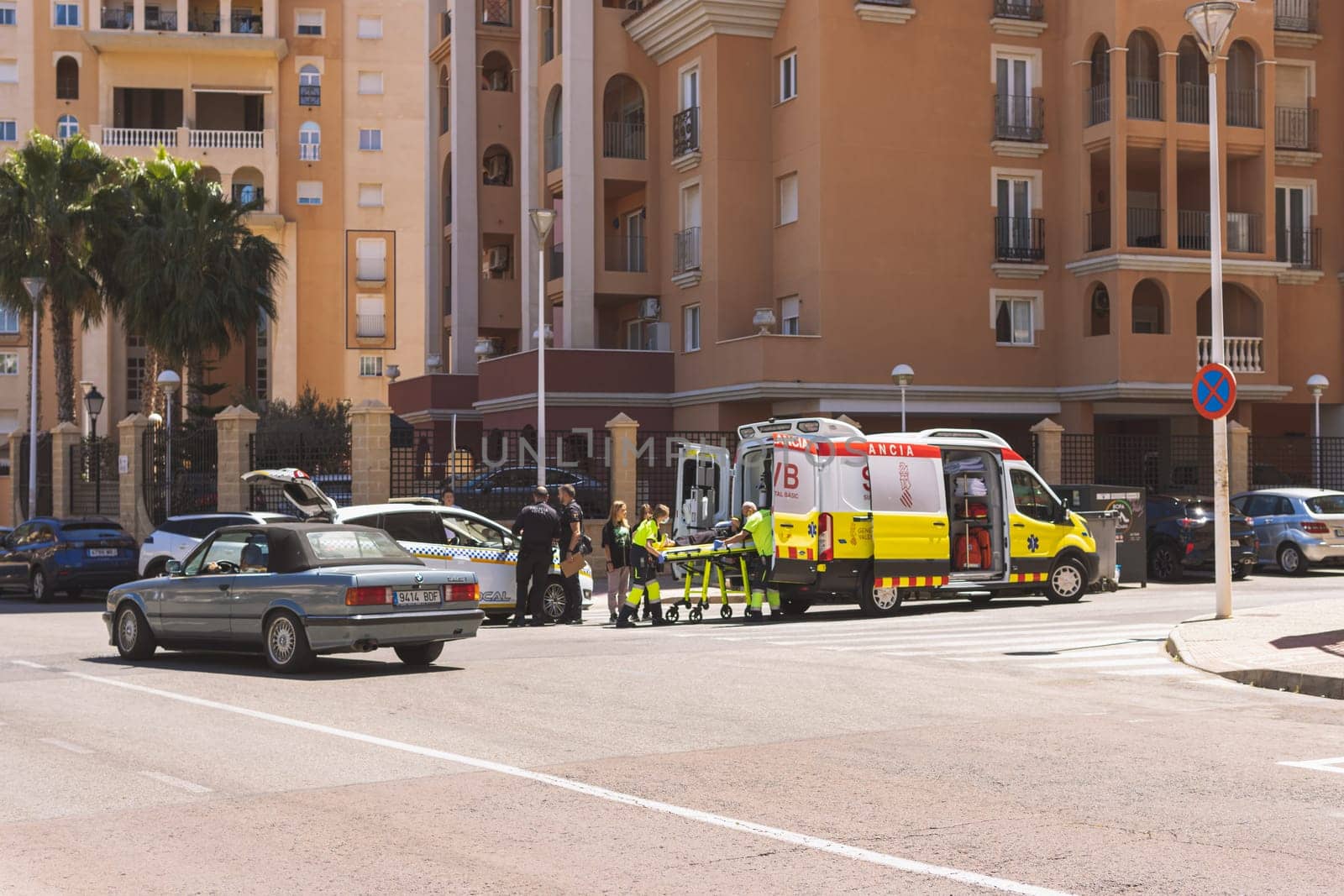 Spain, Torrevieja May 28, 2023, an ambulance on the road picks up a girl who was hit by a car on the road, by PopOff