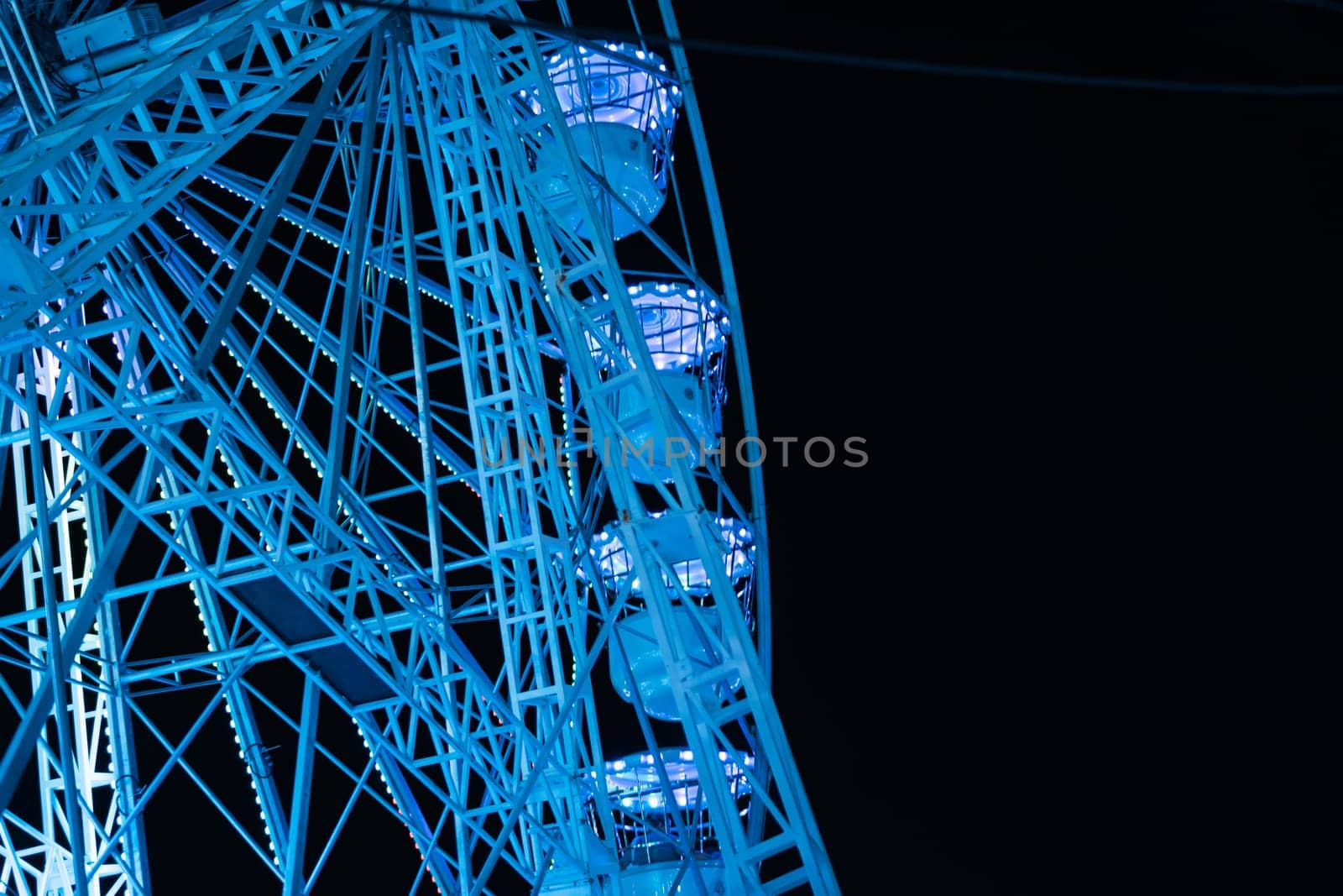 ferris wheel in the lunopark in the evening, close-up there is a place for an inscription by PopOff