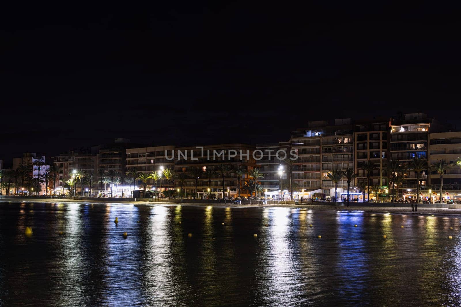 Asphalt road and city skyline with modern building at night. sea evening landscape by PopOff