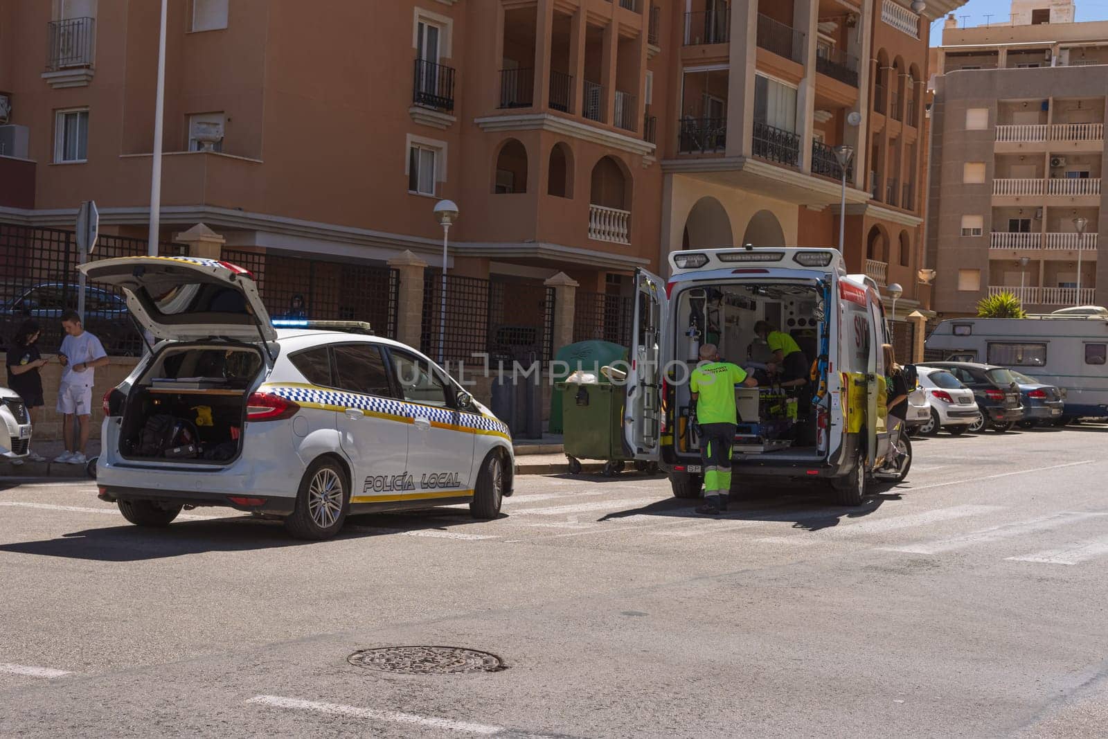 Spain, Torrevieja May 28, 2023, an ambulance on the road picks up a man who was hit by a car on the road, a resort town in Spain near the sea. High quality photo